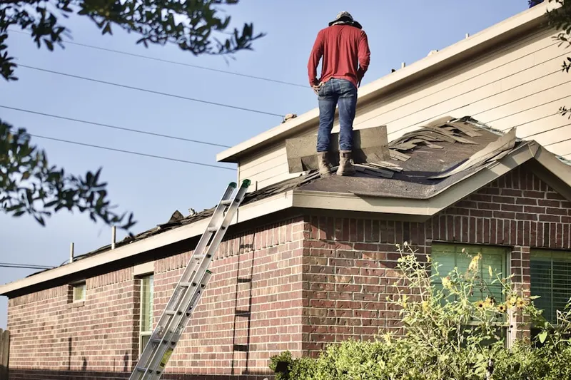 Professional roofer working on a residential roof in Heath Grove
